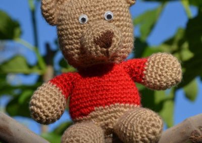 Little crochet bear with red sweater