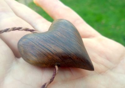 Wooden heart on the palm of the hand